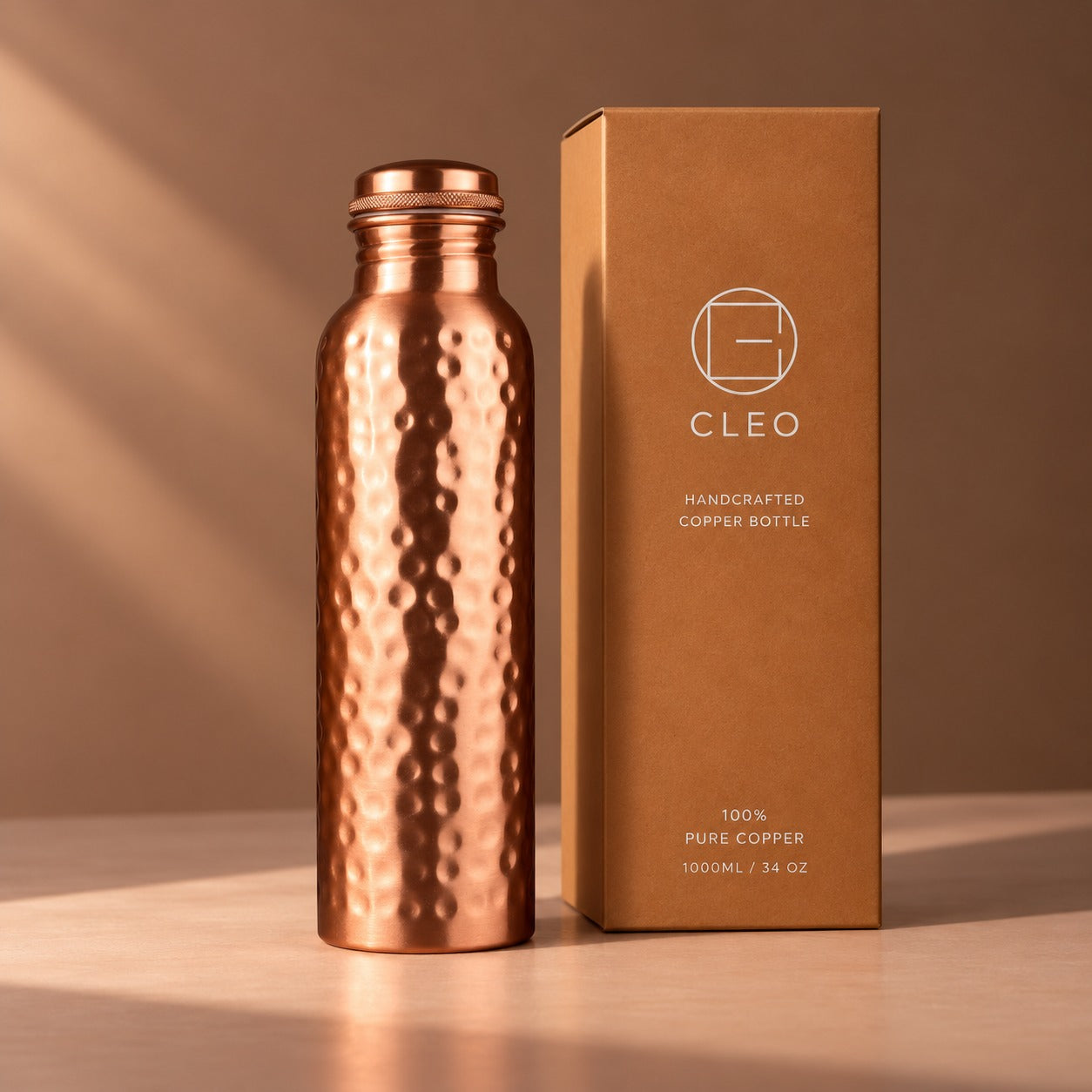 Cleo’s hammered copper bottle standing beside its kraft gift box