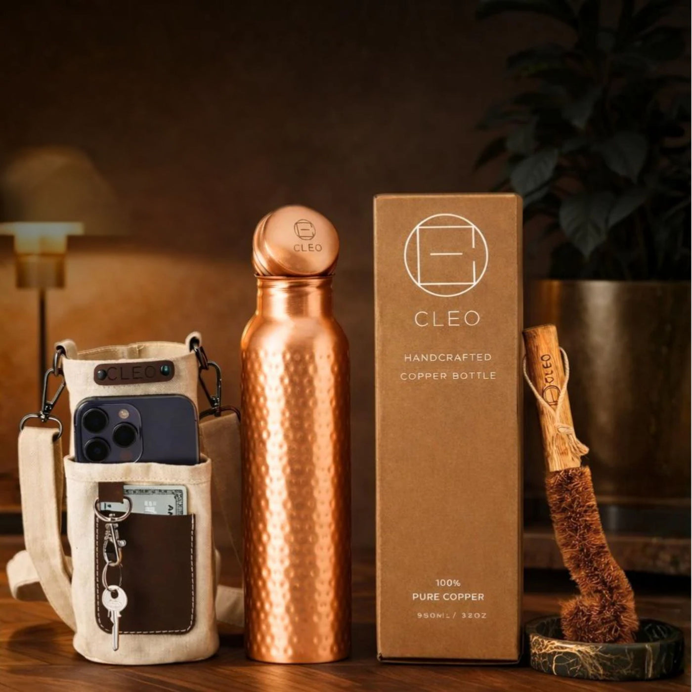 Hammered copper bottle with its canvas travel sleeve, coconut-fibre brush and kraft box