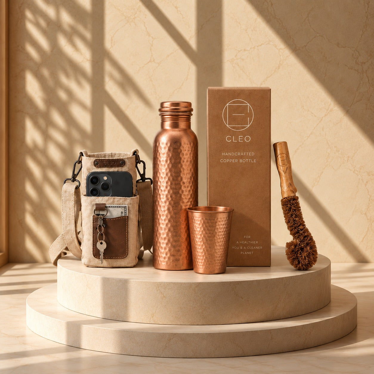 The ritual set: bottle, tumbler, sleeve and brush on a stone plinth
